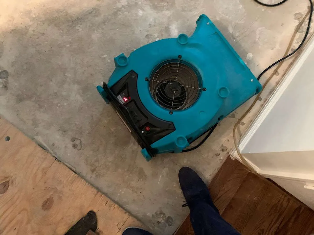Air mover drying subfloor during Commercial Water Damage Restoration in Fayetteville